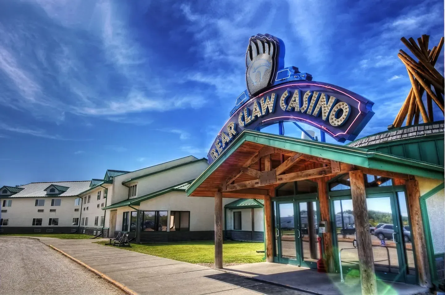 The Bear Claw Casino & Hotel entrance with its timber portico and illuminated sign, Carlyle, Saskatchewan